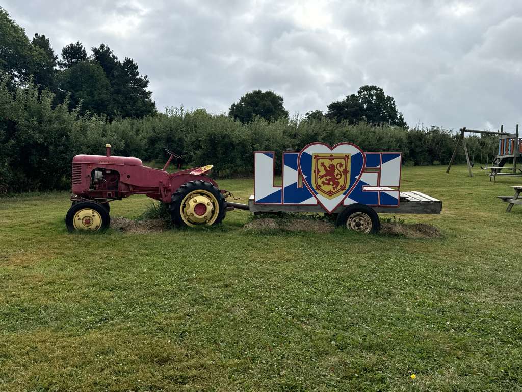Antique Tractor pulling a nova Scotia flag